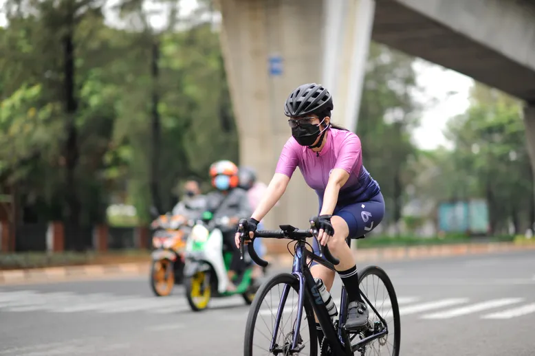 Woman cycling with mask